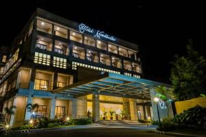 a building with a sign on it at night at Hotel Monticello Tagaytay in Tagaytay