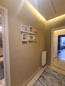 a hallway with a wall with pictures on it at Amman's most prestigious in Amman