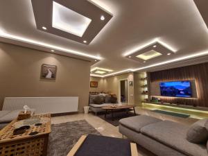 a living room with a couch and a tv at Amman's most prestigious in Amman