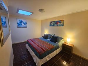 a small bedroom with a bed and a window at Anka Lodge Quitor in San Pedro de Atacama