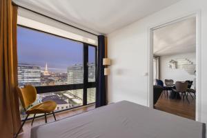 a bedroom with a large window with a view of the city at Paris luxury Apartment with Eiffel Tower View, 1 min metro, parking in Paris
