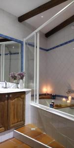 a bathroom with a sink and a window and a tub at Casa Costaneira in Boiro