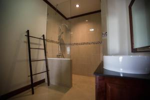 a bathroom with a shower and a sink and a mirror at The Vientiane Capitol "Capitol Residence" in Vientiane +48 photos