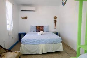 a bedroom with a bed with a cross on the wall at Beachfront Suite 5 Cacique in Vieques