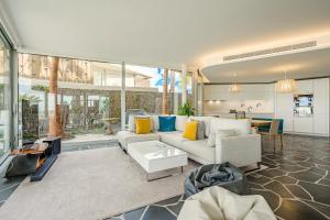 a living room with a couch and a table at Stunning Sunsets Abama in Playa de San Juan