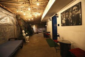 a hallway with a room with a table and chairs at Ranger - Bandra West in Mumbai