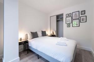 a white bedroom with a large bed and a desk at Fabulous, Modern Apartment, Solihull in Olton