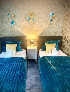 twee bedden in een kamer met blauwe dekbedden bij Fata Morgana in Cochem