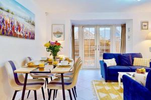 sala de estar con mesa y sofá azul en Dale House, Spacious Home in Central Dartford with Parking, en Kent