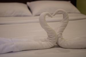 two towels forming a heart on a bed at Kayong's Inn in Dumaguete