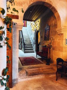 a hallway with an archway and stairs in a building at Four Mansions Hotel in Kayseri