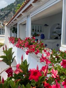 a balcony with flowers on the side of a house at Palazzo Talamo in Positano