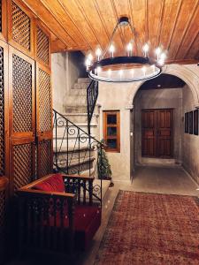 a hallway with a staircase and a chandelier in a building at Four Mansions Hotel in Kayseri