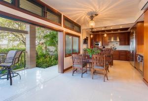 a kitchen and dining room with a table and chairs at 1412 Ridge in Kahana