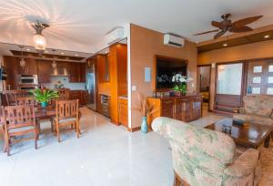 a living room and kitchen with a couch and a table at 1412 Ridge in Kahana