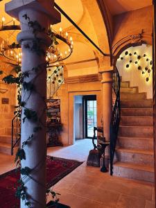 a hallway with stairs and a chandelier in a building at Four Mansions Hotel in Kayseri