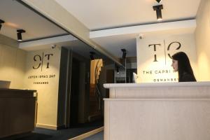 a woman sitting at a counter in a store window at The Capri Hotel Osmanbey in Istanbul