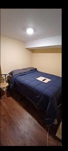 a bedroom with a bed with a blue blanket at Willoughby in Newark