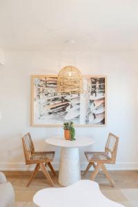 a dining room with a table and two chairs at The Oceanic at The Tarrymore in Wrightsville Beach