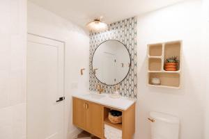 a bathroom with a sink and a mirror at The Oceanic at The Tarrymore in Wrightsville Beach +25 photos