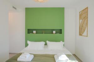 a bedroom with a bed with two towels on it at Villa Mare Monti 3 chambres in Calvi +20 photos