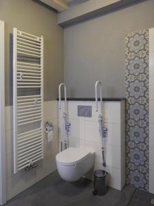 a bathroom with a white toilet in a room at B&B Boerderij La Trappe Deurne in Deurne