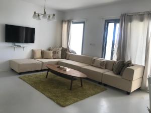 a living room with a couch and a coffee table at El Gouna Swan Lake I Direct Lake View I 3 Master Bedrooms Chalet in Hurghada