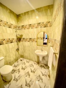 a bathroom with a toilet and a sink at 4 Pyramids inn in Cairo