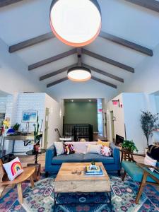 a living room with a blue couch and a table at Monterey Hostel in Monterey