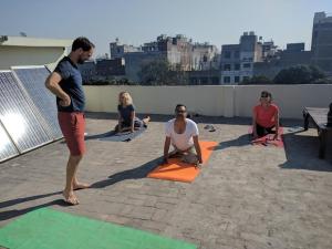 a group of people doing yoga on a rooftop at mye Home stay near golden temple in Amritsar