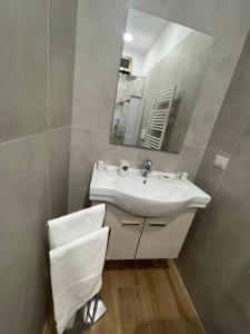 a bathroom with a sink and a mirror at Relax Apartment 39 in Crotone