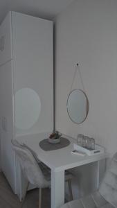 a white table with a mirror and a chair at Nada's room with terrace in Kotor