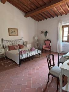 a bedroom with a bed and a chair and a table at Casa Martelli in Seano
