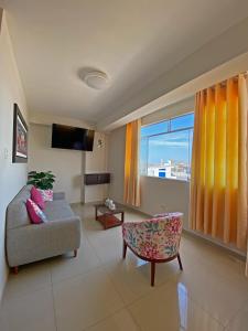 a living room with a couch and a window at Hotel Sengor in Urbanizacion Buenos Aires