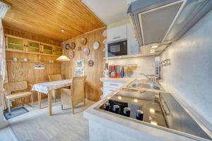 una pequeña cocina con fregadero y mesa en Ferienpark - Haus E, App 0E1108, en Heiligenhafen