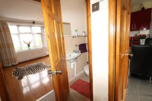 a zebra laying on the floor in a bathroom at 3 Bedroom House-Garden-Stratford-Olympic Park in London