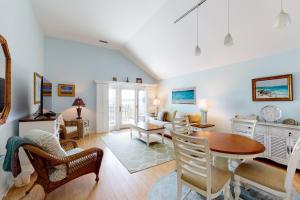 a living room with a table and chairs at 13104 Pelican Watch in Seabrook Island