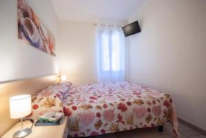 a small bedroom with a bed and a window at Camping Bungalow Lido in Capoliveri