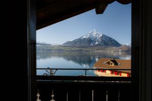 a view of a mountain from a window at Bijou Niesenblick - traumhafter Seeblick - nahe Interlaken - idyllisch in Merligen