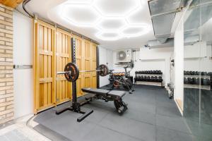 a gym with a bench and weights in a room at Luxury Central Mayfair Townhouse with A/C 3BR 3BA in London
