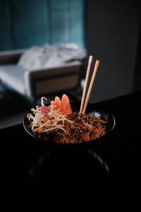 a plate of noodles and chopsticks on a table at Prinsotel La Dorada & Spa in Playa de Muro