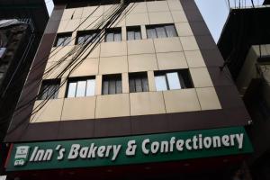 a tall building with a sign in front of it at Kajal's Home stay in Siliguri