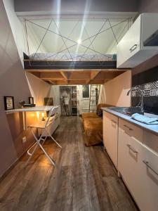 a kitchen with a loft bed in a room at La Tiny : Adorable petit studio /parking gratuit. in Angoulême