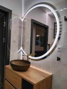a bathroom with a sink and a mirror at Aster Aparts Sopot in Sopot