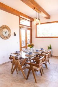 comedor con mesa, sillas y reloj en Casa Bonita, en La Esperanza