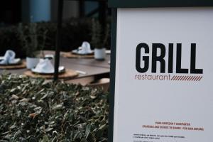 a sign that says chill next to a hedge at Prinsotel La Dorada & Spa in Playa de Muro