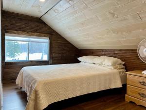 a bedroom with a bed and a window in a room at Chalet Romanov in Saint-René-de-Matane