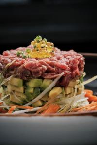 a pile of food on a plate with vegetables at Prinsotel La Dorada & Spa in Playa de Muro