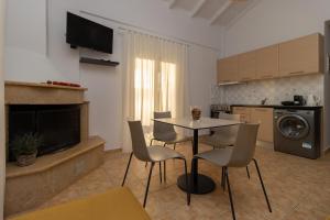 a kitchen with a table and chairs in a room at Lagouvardos Beach Apartments in Marathopoli