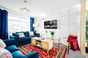 uma sala de estar com um sofá azul e uma mesa em Unique 2 Bedroom House - Free Wifi & Netflix - Garden - Parking - 4VC em Minworth
